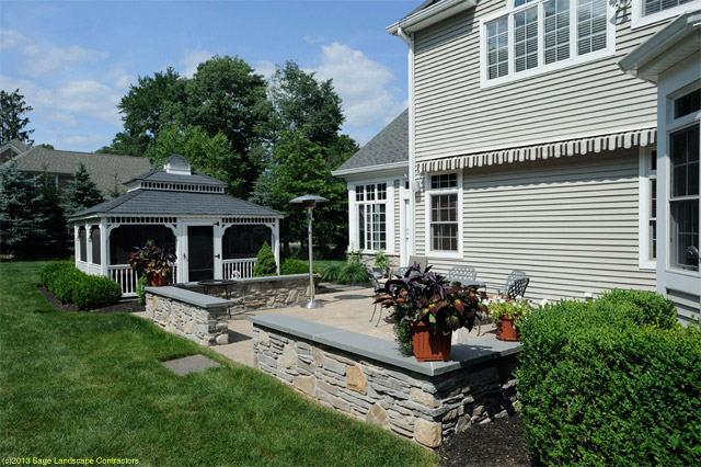 Concrete Patio Construction with stone sitting wall